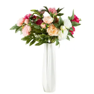 Bouquet di fiori di peonia artificiali in vaso bianco, elegante decorazione per la tavola.