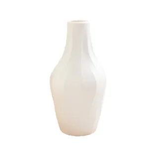 Modern minimalist white plastic twisted vase for home desktop decoration and floral art.