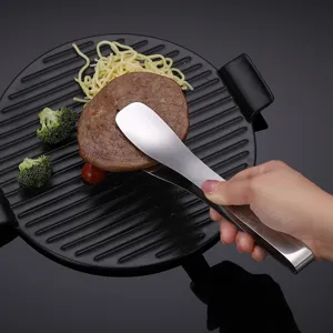 Stainless steel food tong kitchen BBQ steak clamp for cooking and grilling meat securely.