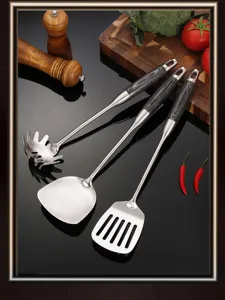 Stainless steel kitchen utensil set detail showing spatula and slotted spoon with wood grain handle.