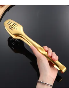Gold stainless steel food tong detail shot, crown cutout design and anti-slip teeth.