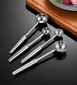 Stainless steel ice cream scoop set detail showing polished metal surface and ergonomic handle.