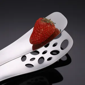 Stainless steel food tong with hollow design and fresh strawberry, ideal for kitchen and BBQ.