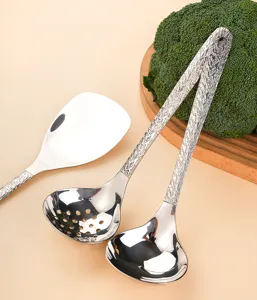 Stainless steel hammered soup spoon and colander kitchen cooking utensil set detail view.