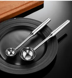 Stainless steel ice cream spoon detail view, showing smooth polished dual scoop head design.