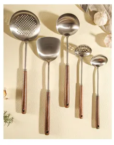 Stainless steel kitchen utensil set with wooden handles, spatula and soup ladle.