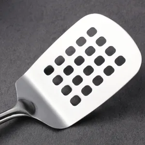 Stainless steel slotted spatula for kitchen cooking, durable metal turner with drain holes.