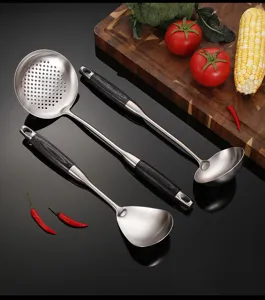 Stainless steel kitchen utensil set detail showing slotted spoon, soup ladle, and spatula.
