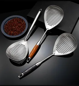 Stainless steel slotted spoon kitchen skimmer strainer with wood grain handle for home cooking.