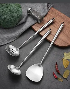 Stainless steel kitchen utensil detail showing premium brushed finish and long handle design.