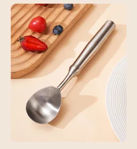 Stainless steel ice cream scoop close-up showing metallic texture and ergonomic handle.