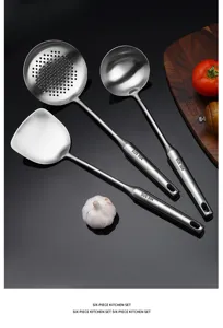 Stainless steel kitchen utensil set including spatula colander and ladle for cooking.