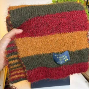 Detailed close-up of the cozy striped wool blend winter scarf, showcasing soft texture.