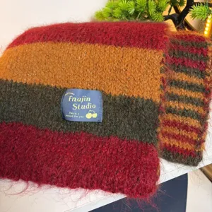 Detailed view of cozy striped winter scarf, thick wool blend fabric with warm multicolored pattern.