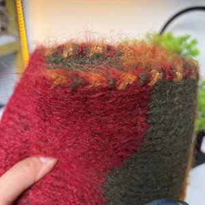 Close-up fabric detail of cozy fuzzy striped wool-blend winter scarf with soft mohair texture.