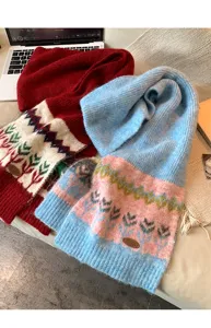 Detailed view of cozy winter knit scarf with Nordic Fair Isle jacquard design and texture.