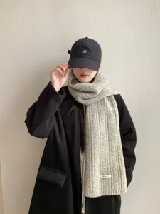 Classic cable-knit wool blend scarf in light grey, offering cozy warmth and winter style.