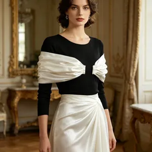 Detalle de top negro con elegante chal blanco de satén para vestido de noche formal.