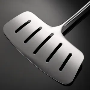 Stainless steel slotted spatula for fish and steak, wide kitchen turner with draining holes.
