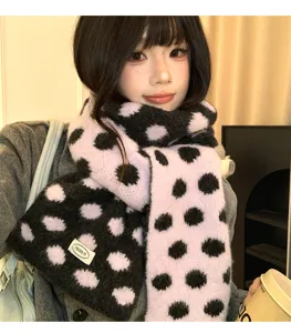 Cozy knit scarf detail view, stylish pink and black polka dot winter soft warm neck wrap.