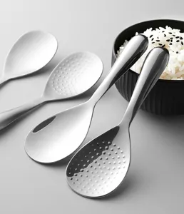 Stainless steel rice paddle detail showing smooth and textured anti-stick surface design.