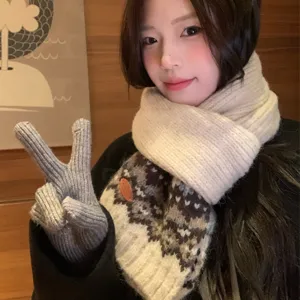 Beige Fair Isle knit scarf with cozy wool texture and grey gloves for winter warmth.
