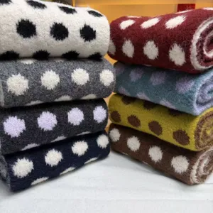 Wool blend polka dot knitted scarf detail, cozy winter neck warmer with stylish contrast pattern.