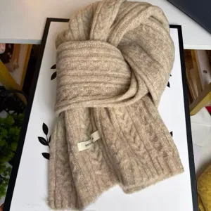 Detailed close-up of a cozy beige cable knit woolen scarf, soft winter warm accessory for daily.