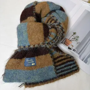 Close-up of cozy wool blend striped knitted scarf in brown and blue, soft thick warm winter.