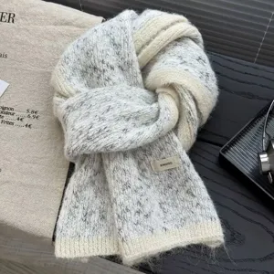 Cozy wool blend knit scarf in chic grey and white colorblock, warm winter fashion accessory.