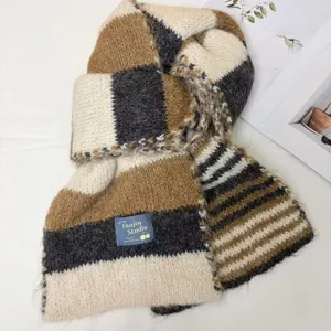 Detailed view of cozy colorblock knit scarf, soft warm winter neck wrap texture.