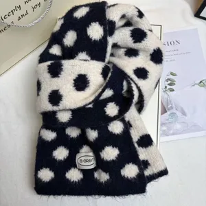 Close-up detail of a Korean style black and white polka dot knit scarf, soft and cozy winter accessory.