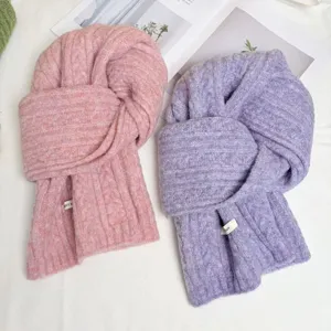 Cozy winter cable knit scarf detail, soft wool blend texture, warm purple and pink neckwear.