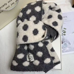 Close up of winter cozy polka dot knit scarf detail, soft wool blend fabric texture.