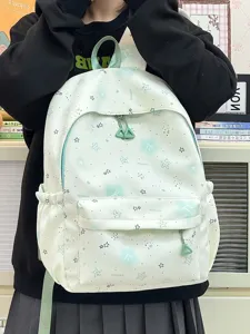 Detail view of cute mint green student backpack with star prints, multi-pocket and durable straps.
