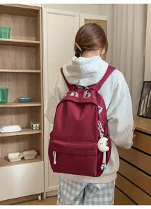 Zaino casual in tela per uso quotidiano, borsa scolastica leggera con ciondolo carino e tasche.