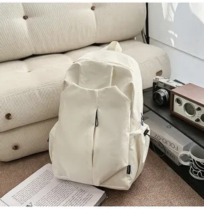 Detail view of minimalist casual beige backpack showing large capacity and zipper pocket design.