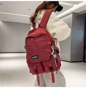 Durable canvas student backpack with plaid front flap, large capacity casual travel bag.