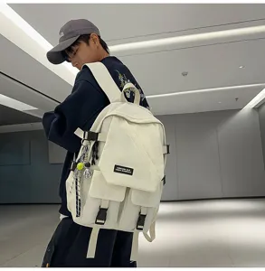 Workwear style canvas backpack detail featuring multi pockets, secure buckles and charms.