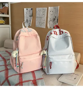 Dettagli dello zaino scolastico casual in tela per studenti, borsa leggera rosa e azzurra.
