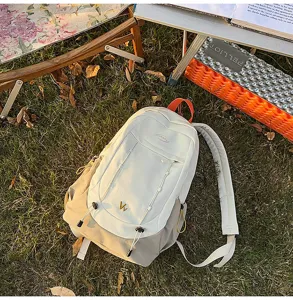 Detailed close-up view of the color-blocked student backpack showing spacious storage capacity.