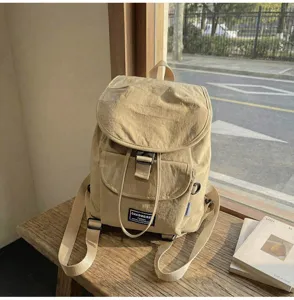 Minimalist khaki canvas backpack detail, casual daily commuter school bag with flap pocket.