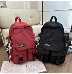 Utility style large capacity plaid student backpack detail view showing dual colors and pockets.