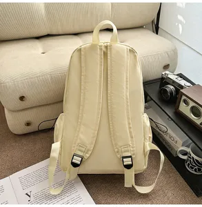 Minimalist beige casual backpack back view detail, showing adjustable shoulder straps and durable fabric.