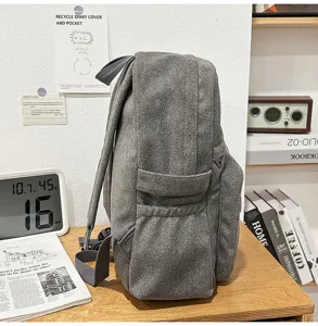 Detailansicht des retrograuen Canvas-Rucksacks mit Seitentaschendesign und langlebigem Stoff.