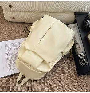 Minimalist grid backpack detail view in neutral tone, casual daypack for commute and travel, off-white.