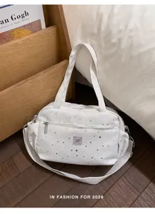 White star print shoulder bag detail shot, casual fashion crossbody design with zipper pocket.
