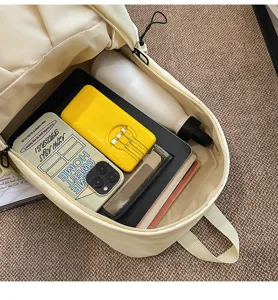 Interior detail of the beige casual backpack showing large capacity and multi-compartment design.