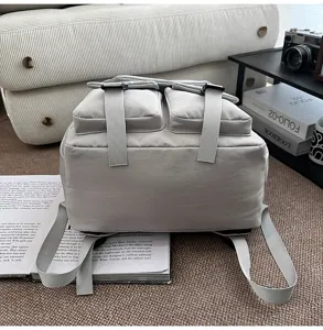Utility style grey backpack with front pockets and straps, casual travel bag for students.