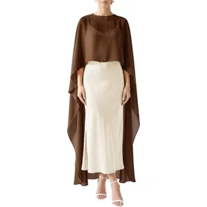 Detail shot of elegant brown chiffon cape overlaying white satin dress, fine tailoring and fabric.